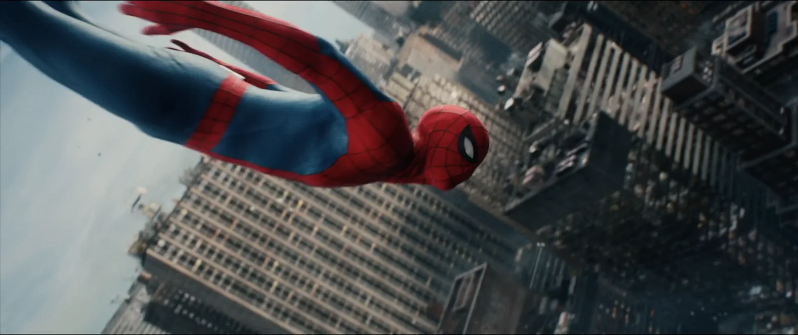 Spider-Man swings past the towers in a sweeping aerial shot.
