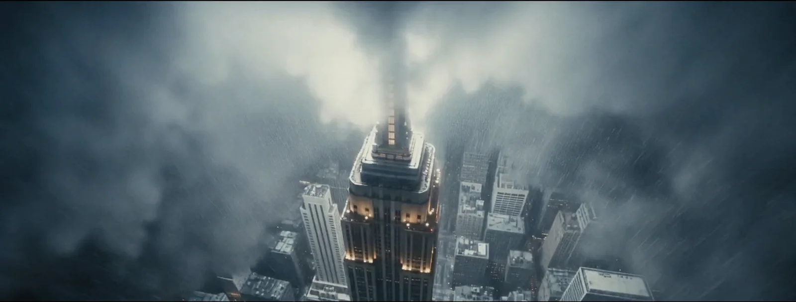 A luminous tower emerges from blue clouds in the music-video world.