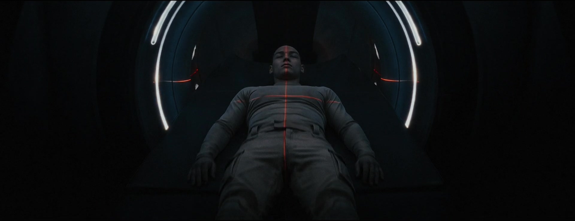 A reclining figure is framed by a white circular scanner and red targeting lines.
