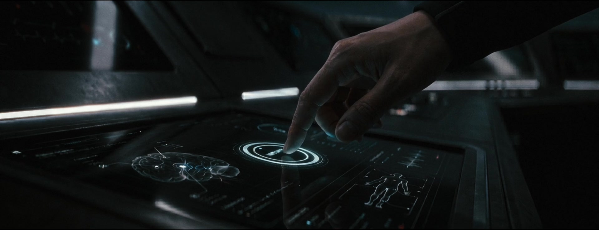 A fingertip touches a luminous circular control beside a brain visualization.