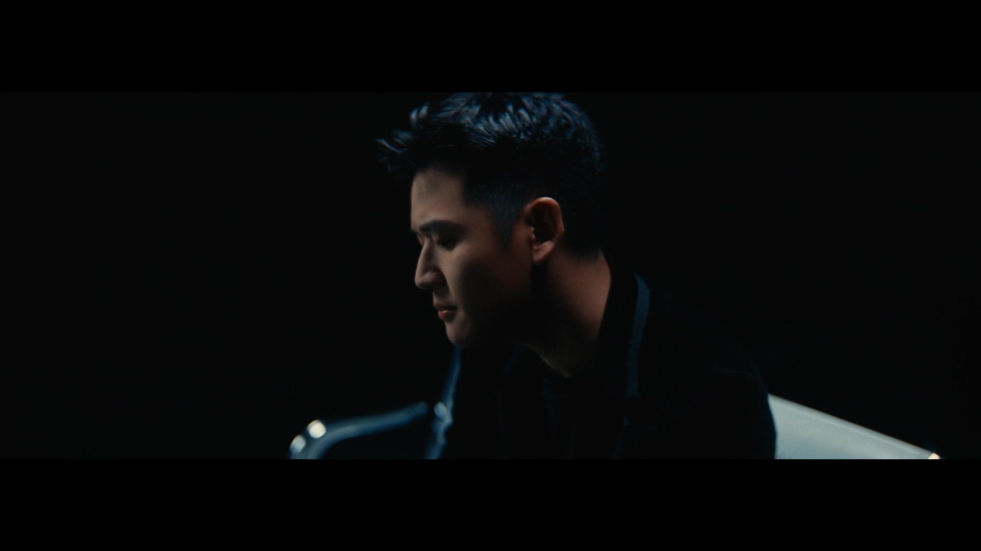 Eric Chou — Close portrait in a dark piano performance