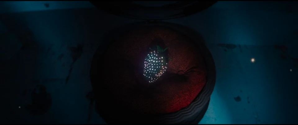 A glowing berry within a circular red form.